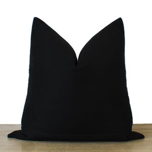 May include: A black pillow cover with a simple, elegant design. The cover is made of a soft, durable fabric and is perfect for adding a touch of sophistication to any room.