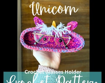 May include: Crocheted unicorn glasses holder in pink, purple, and blue with a white mane and a gold horn. The text "Crochet Pattern PDF File" is below the holder.