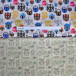 May include: Two distinct fabric patterns. The top section features a white background with a repeating print of colorful Mandalorian helmets in orange, blue, yellow, and black. The bottom section displays a light green grid with the text The Child.