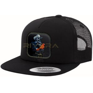 May include: Black trucker hat with a square patch featuring a skeleton cowboy holding a rooster. The hat has a curved brim and a mesh back. The text "RIVERA" is visible on the patch. The hat has a snapback closure.