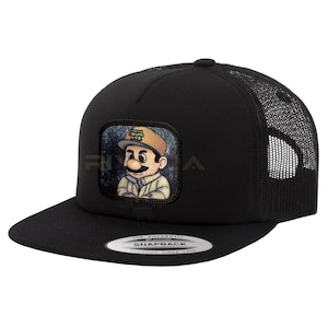 May include: Black trucker hat with a mesh back and a flat brim. The front features a square patch with a cartoon image of a character with a mustache and the text "CHAPO BROS". The hat has a snapback closure.
