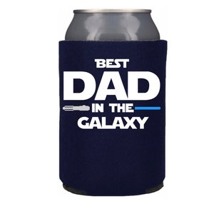 May include: Navy blue can cooler with white text that reads "Best Dad in the Galaxy" with a lightsaber graphic.