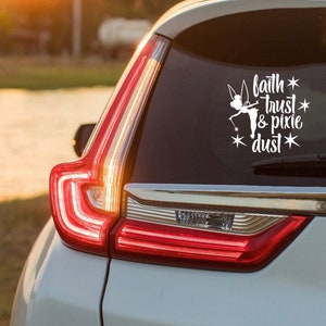 May include: White car with a rear window sticker that says "faith * trust * & pixie dust" with a silhouette of Tinkerbell from the Disney movie Peter Pan.