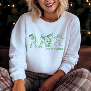 May include: White sweatshirt with a green graphic of a person walking and the text "ooh aah... that's it I'm not going."