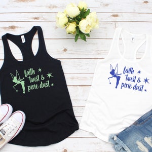 May include: Two tank tops with a Tinkerbell silhouette and the text "faith * trust & pixie dust *" printed on them. One tank top is black with green text and the other is white with blue text.
