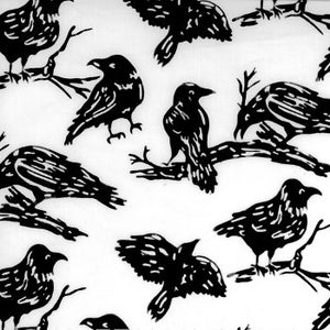 May include: A white fabric featuring a repeating pattern of black crows in various poses, including birds perched on bare branches and birds in flight. The graphic design uses high-contrast black ink on a solid white background.