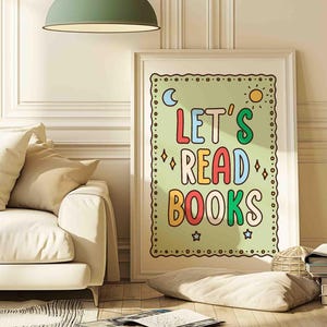 May include: A white ceramic mug with a black handle and the text "But First, Coffee" in a bold, black font. The mug is set against a blurred background, suggesting a cosy setting.