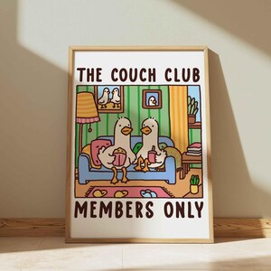 May include: A colorful illustration of two ducks sitting on a blue couch with the text "The Couch Club Members Only". The ducks are holding snacks and drinks. The illustration is set in a living room with a lamp, plants, and books.
