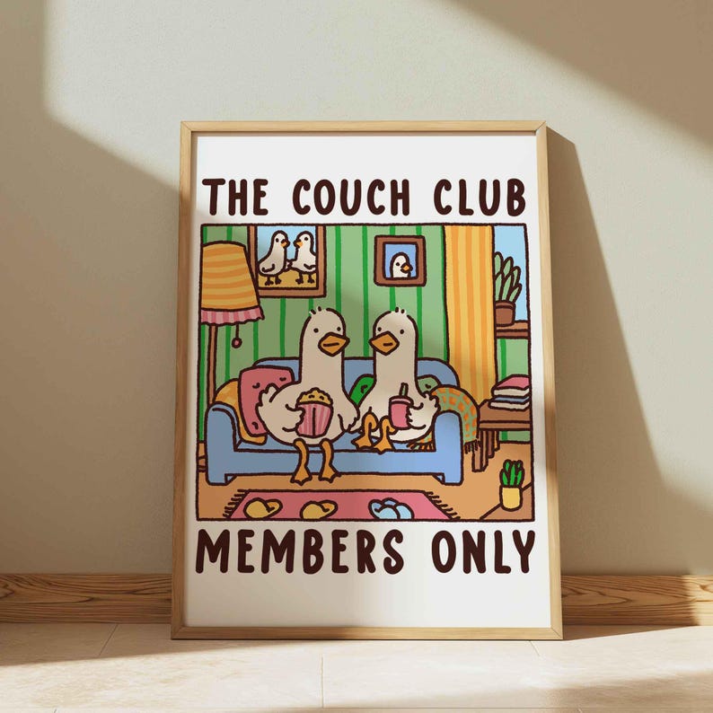 May include: A colorful illustration of two ducks sitting on a blue couch with the text "The Couch Club Members Only". The ducks are holding snacks and drinks. The illustration is set in a living room with a lamp, plants, and books.