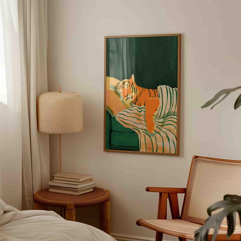 May include: A framed art print featuring a stylized tiger lounging on a green and striped sofa. The tiger is depicted in shades of orange and brown, with a relaxed pose. The artwork has a modern, minimalist aesthetic.
