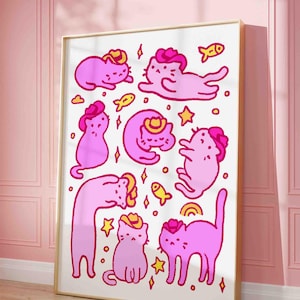 May include: A framed print featuring a whimsical illustration of pink cats wearing cowboy hats. The cats are in various poses, surrounded by yellow stars, fish, and diamonds. The artwork has a playful, cartoonish style.