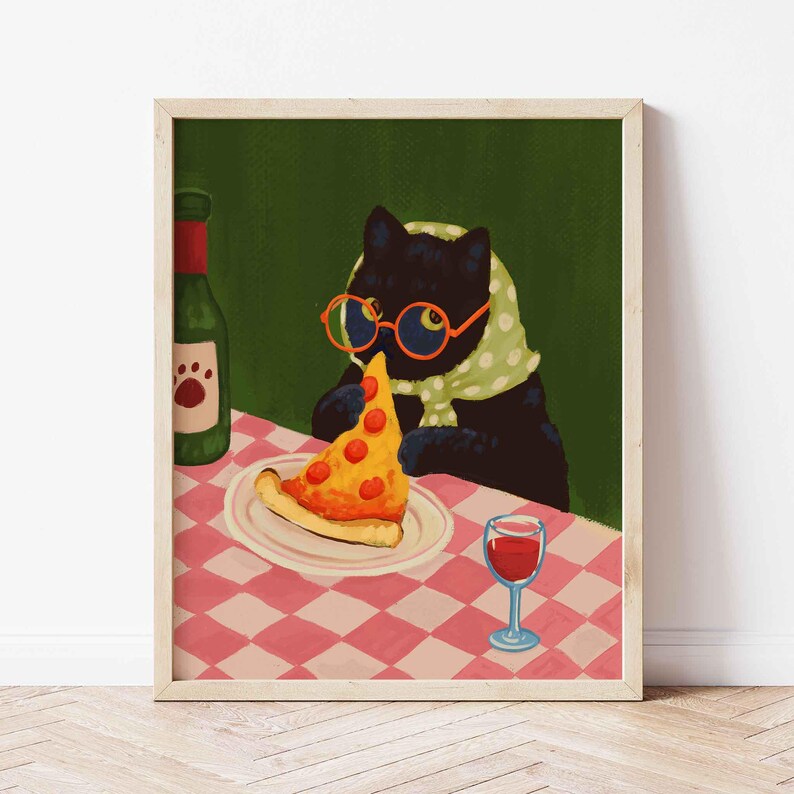 May include: A framed art print depicts a black cat wearing glasses and a scarf, enjoying a slice of pizza and a glass of red wine. A green wine bottle with a paw print label sits on the checkered tablecloth. The artwork has a whimsical, illustrative style.