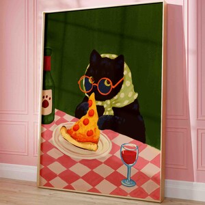 May include: A framed art print featuring a black cat wearing glasses and a scarf, enjoying a slice of pizza. A bottle of wine and a glass of red wine are on the table. The table has a red and white checkered tablecloth.