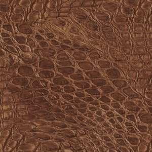 May include: Brown faux leather with a crocodile skin pattern.