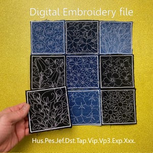 May include: Nine square fabric patches with floral embroidery designs. The patches are in shades of blue and black, with white thread used for the floral patterns. The text "Digital Embroidery file" is at the top. The patches are arranged in a grid.