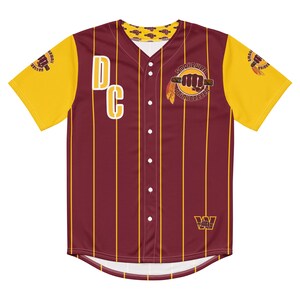 May include: A maroon and gold baseball jersey with vertical gold stripes. The jersey features the letters "DC" in white, a fist graphic with text, and the team logo. The sleeves are yellow with a fist graphic.