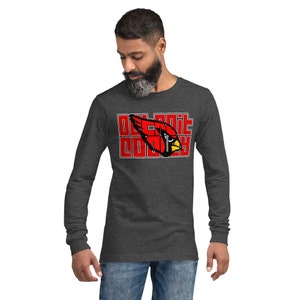 May include: A dark heather grey long-sleeved shirt with a red cardinal graphic and the text "Oakland County" in white.