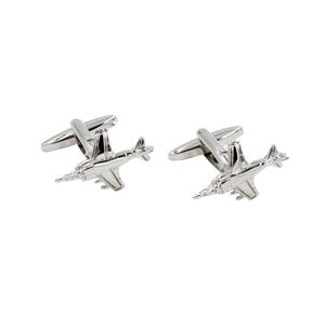 May include: A pair of silver-colored airplane cufflinks. Each cufflink features a detailed miniature airplane design with wings, a fuselage, and tail. The cufflinks have a polished, reflective finish and a classic T-bar closure.