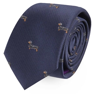 May include: A navy blue tie featuring a repeating pattern of dachshund dogs. The dogs are black with tan detailing. The tie is rolled, displaying the fabric's texture and pattern.