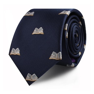 May include: A navy blue tie featuring a repeating pattern of embroidered open books in tan and white. The tie is rolled, displaying the fabric's texture. A smart accessory suitable for professional or academic wear.