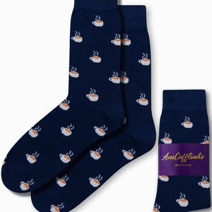 May include: A pair of navy blue socks with a white coffee cup pattern. The socks are packaged with a label that says "AusCufflinks AUSTRALIA".