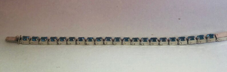 handmade one of a kind Swiss Blue Topaz and silver tennis bracelet
