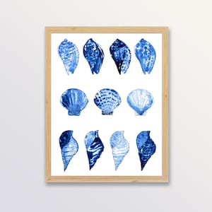 May include: A framed print of a watercolour illustration of blue seashells. The seashells are arranged in three rows of three. The print is on a white background.