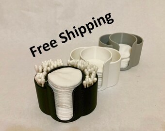 May include: Three round cotton swab and cotton round organizers in black, white, and gray. The organizers have two compartments, one for cotton swabs and one for cotton rounds.