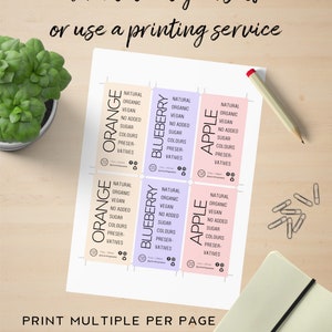 May include: Printable labels for food products, featuring orange, blueberry, and apple flavours. The labels are designed with a natural, organic, vegan, and no added sugar theme. The text "Print multiple per page A4/letter size" is included at the bottom.