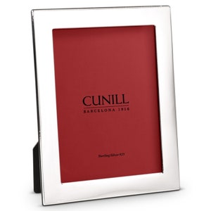 May include: A silver picture frame with a red mat and the text "CUNILL BARCELONA 1916 Sterling Silver 925".