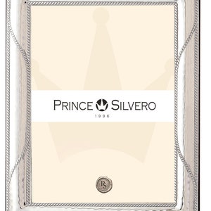 Könnte beinhalten: Silberner Bilderrahmen mit einem Seil-Design-Rand. Der Rahmen hat eine strukturierte Oberfläche und ein silbernes Kronenlogo mit dem Text "Prince Silvero 1996".