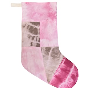 May include: Pink and brown tie-dye Christmas stocking with a white loop at the top.