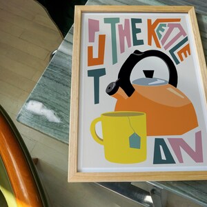 put the kettle on colourful print in a wood frame
