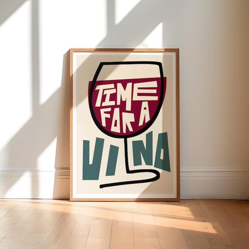 May include: A framed print with a stylized illustration of a wine glass. The glass is filled with red wine and the text "TIME FOR A VINA" is written in a bold, colorful font.