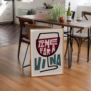 May include: A framed poster with a stylized illustration of a wine glass with the text "Time for a Vina" in red, blue, and white.