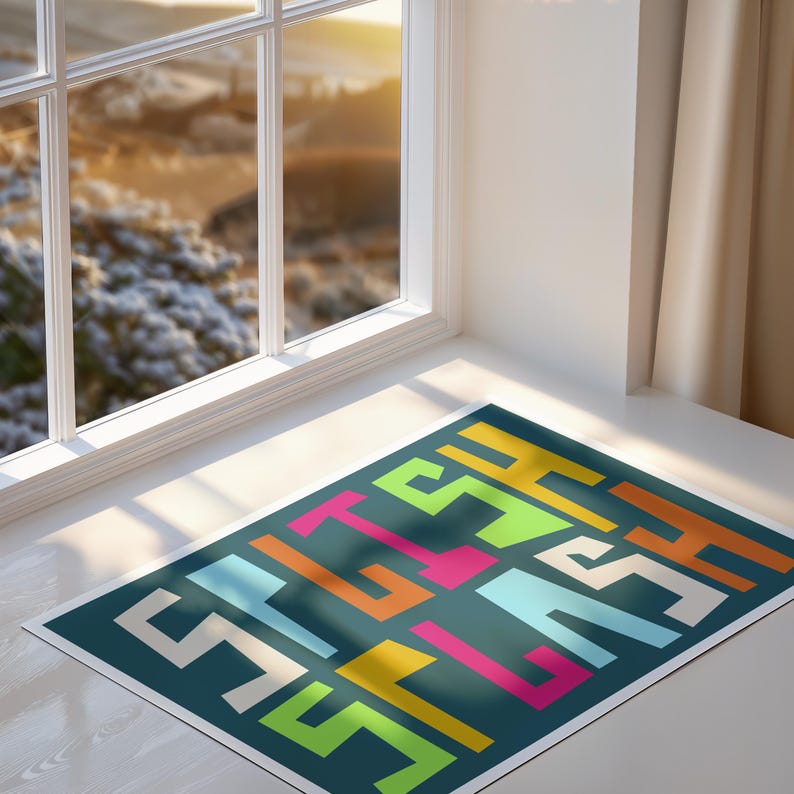 May include: A rectangular rug with a teal background and a colorful geometric design. The design features the word "STYLE" in white, orange, yellow, pink, and green block letters. The rug is placed in front of a window.