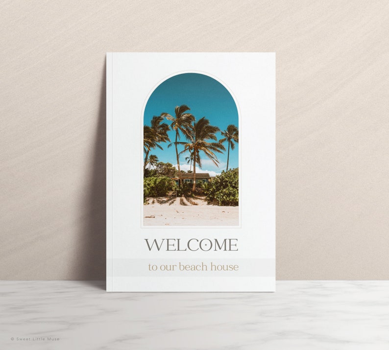 Beach house welcome sign featuring a minimalist design. A white card with a beige arched frame showcases a tropical scene: palm trees framing a light-blue beach house under a clear sky.  Text reads: 'WELCOME to our beach house' in a simple serif font. The overall aesthetic is calming and evokes a vacation vibe. Ideal for beach house decor or as a summer-themed printable.