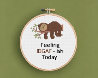 May include: Embroidered hoop art featuring a cartoon sloth sleeping on a branch with the text "Feeling IDGAF - ish Today".