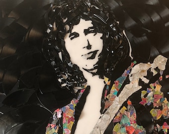 May include: A black and white portrait of a person, created from vinyl records. The person's face is white, with black hair and clothing. The jacket is made of colorful mosaic pieces.