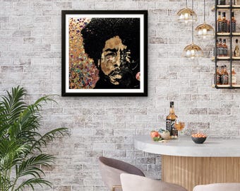 May include: Framed portrait of a man with black hair and a beard. The artwork features gold and black tones, with a textured background of gold and colorful accents. The portrait is displayed on a white brick wall.