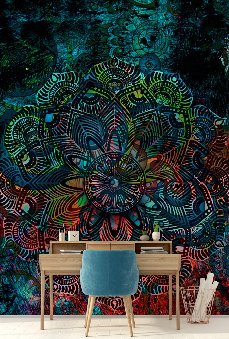 May include: A teal blue office chair with a wooden desk in front of a colourful mandala wall mural. The mandala features intricate patterns in shades of blue, green, red, and yellow.