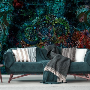 May include: A teal blue velvet sofa with a grey throw blanket and striped cushions in front of a colourful abstract wall mural.