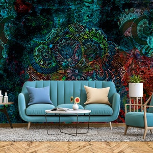 May include: A living room interior design featuring a teal blue sofa and armchair, a coffee table, and a rug. The wall is adorned with a large, colourful mandala-style pattern.