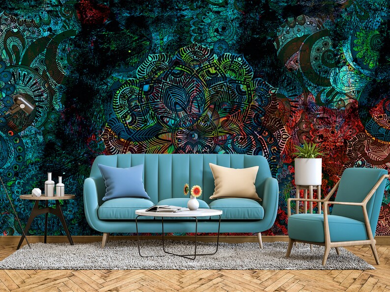 May include: A living room interior design featuring a teal blue sofa and armchair, a coffee table, and a rug. The wall is adorned with a large, colourful mandala-style pattern.