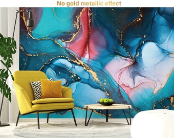 May include: Abstract art wallpaper in shades of teal, blue, and pink with gold accents. A yellow armchair with pillows sits in front of the wall. A small table with a bowl of green apples is in front of the chair.
