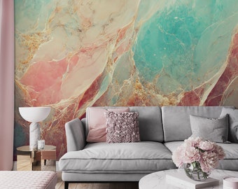 May include: A gray couch with two pillows and a vase of pink flowers on a white coffee table in front of a wall with a colorful abstract marble pattern.