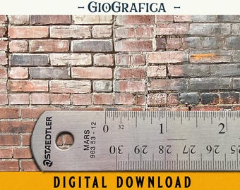 May include: A close-up of a metal ruler with the brand name "Staedtler Mars" and the model number "963 53-12" printed on it. The ruler is marked in centimeters and inches. The ruler is lying on top of a brick wall.