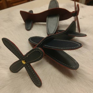 Fantastic Leather by plane propeller moves the wings and tail fin come out I hand cut each one so they&#39;re all different signs by me. Enjoy!