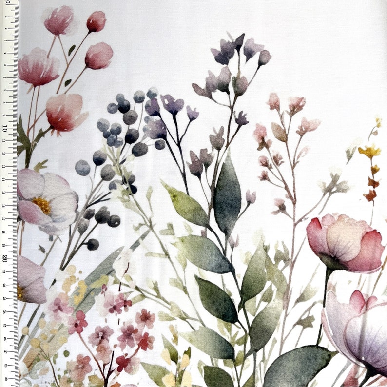 May include: A watercolor floral print fabric featuring delicate pink and purple flowers, green leaves, and small berries on a white background.