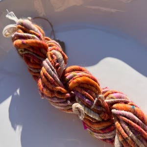 Handspun Art Yarn with Wool, Viscose and Sari Silk Fibers (Pink Orange) Single Ply 13.5 yds